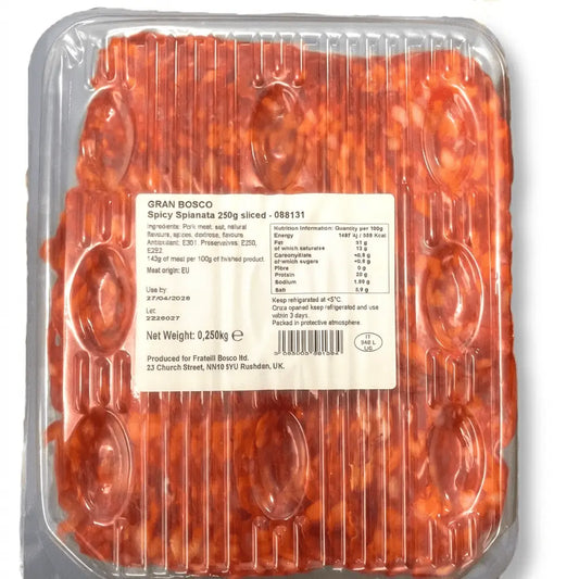 Gran Bosco Italian Spianata Piccante packaged in a clear plastic tray with a black label, shown on a dark textured background with sliced cured meat, chili peppers, and Italian promotional text.