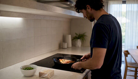 Slice of wood-fired pizza reheating in skillet on stove