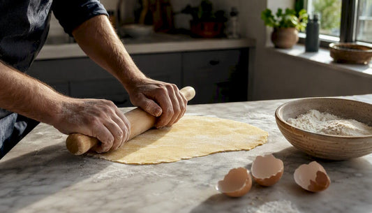 Hands kneading fresh pasta dough with 00 flour