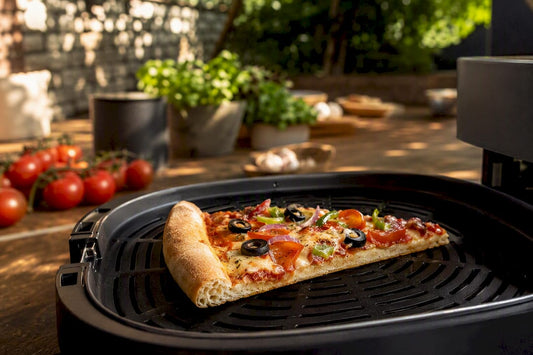 Pizza slice placed in air fryer basket