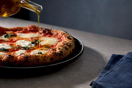 Extra virgin olive oil drizzled over pizza