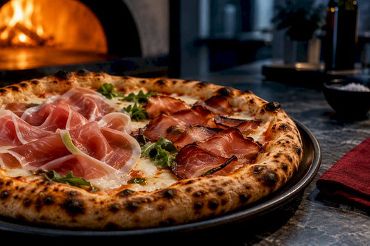 Speck and prosciutto arranged on pizza